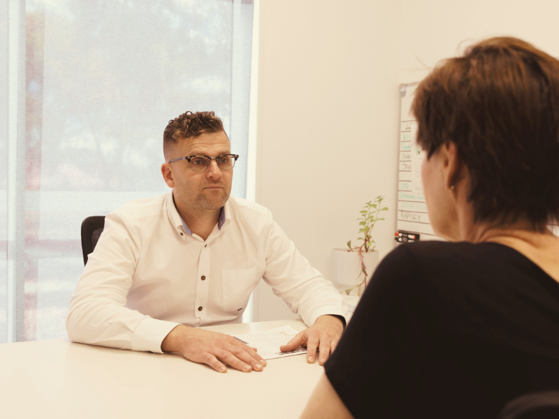 Jonathan at desk with legal advice client